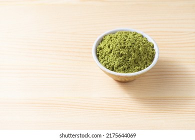 Henna Powder In Cup On Space Of Pine Wood Background