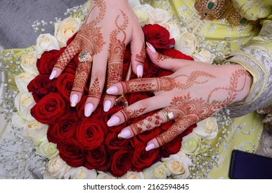 Henna Tattoo on Bride's Hand.Moroccan wedding preparation henna party. Temperate white mehndi. Modern mehendi art.