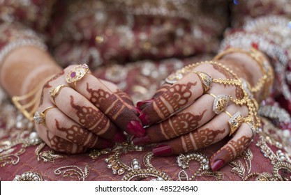 Henna Tattoo's on an Indian bride's hands with Golden jewellery
