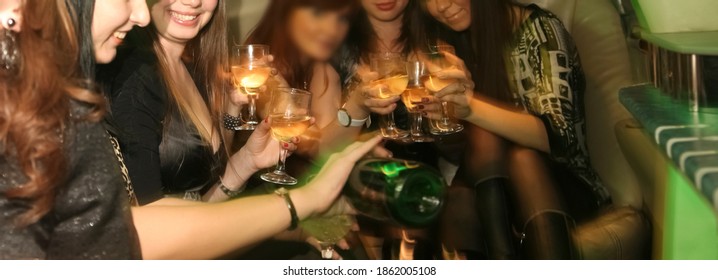 Hen-party. Woman Pours Champagne Into Glasses For Girlfriends. Female Sit At The Car And Drink Champagne Together. Bachelorette Party. No Faces.