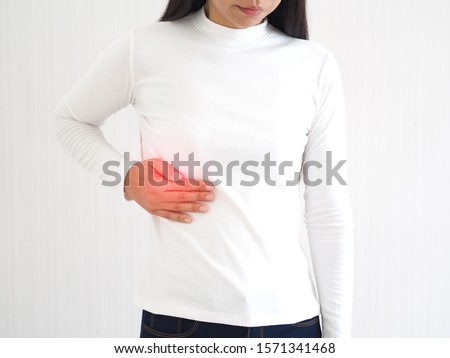 hepatitis and cirrhosis, including bile duct cancer in woman and she touching in the upper right portion of abdomen and above stomach symptoms of pain and suffering use for health care concept.