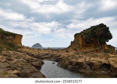 Heping Island's iconic rock overlooks Keelung Island, providing a breathtaking view of the vast ocean, rugged coastline, and distant islet. - Powered by Shutterstock