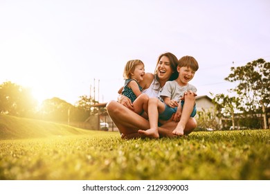 Her boys fill her life with joy. Cropped shot of a young family spending time together outdoors. - Shutterstock ID 2129309003