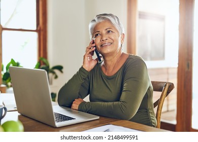 Her Broker Just Called With Some More Good News. Shot Of A Mature Woman Talking On A Cellphone While Working On A Laptop At Home.