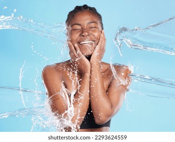 Her warmth will draw you in  Shot beautiful young woman being splashed and water against blue background 