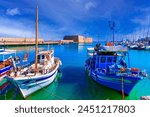 Heraklion, Crete island, Greece: Panoramic view with boats and The Koules or Castello a Mare in the background - a fortress at the entrance of the old port of Heraklion city