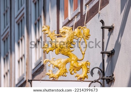 Heraldic lion from the coat of arms on the signs in the old European city