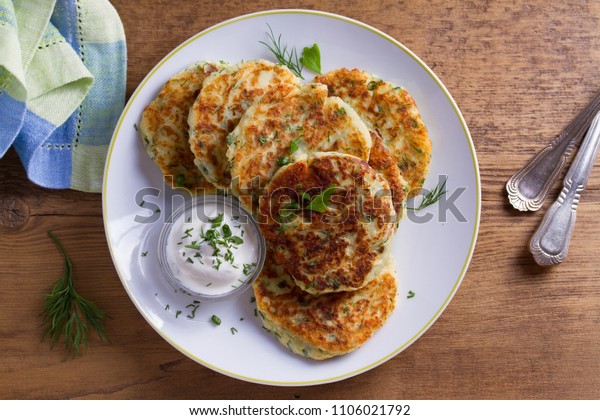 Herb and\
Cheese Mashed Potato Cakes. Potato Pancakes. Vegetable fritters.\
View from above, top studio\
shot