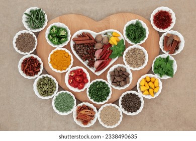 Herb and spice selection in porcelain crinkle bowls on a wooden board and heart shaped porcelain dish. - Powered by Shutterstock