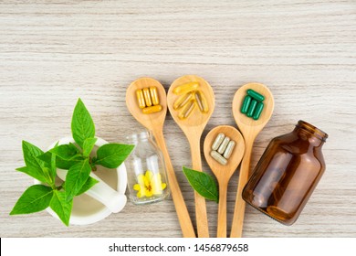 Herbal capsule from herbs nature for good health, vitamin, mineral supplement pills for medication disease on wooden medical background with copy space, medicine and drug concept - Shutterstock ID 1456879658