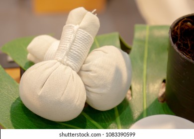 Herbal compress ball on plastic realistic leaf on wood table, Thai massage, Spa theme concept