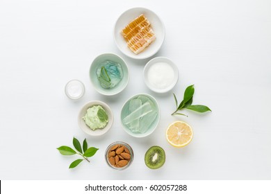 Herbal dermatology cosmetic hygienic cream for beauty and skincare product. honey, lemon, almond, kiwi, cucumber, aloe vera, salt, yogurt on white background.