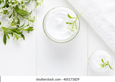 Herbal Face Cosmetic Cream With Flowers Hygienic Skincare Product Wellness And Relaxation Medical Mask In Glass Jar On White Background