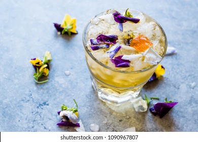 Herbal Iced Tea Cocktail with Edible Flowers and Crushed Ice. - Powered by Shutterstock