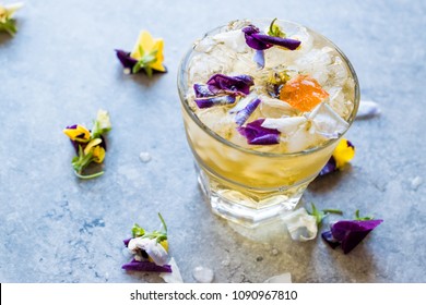 Herbal Iced Tea Cocktail with Edible Flowers and Crushed Ice. - Powered by Shutterstock