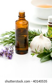 Herbal medicine with herbs and a cup of tea on table. Isolated white background. Studio shot