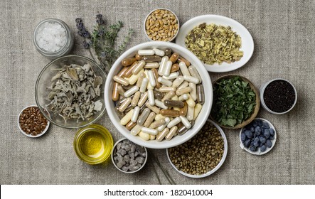 Herbal and mineral organic dietary supplements in capsules. Ingredients in for food supplements in plates - Shutterstock ID 1820410004
