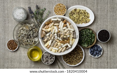 Herbal and mineral organic dietary supplements in capsules. Ingredients in for food supplements in plates