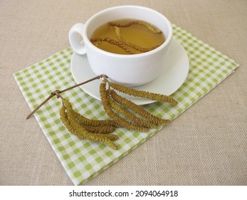 Herbal tea with hazel catkins, hazel flowers from hazel shrub