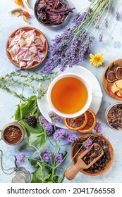 Herbal tea ingredients. Herbs, flowers, and fruit, shot from the top with a cup of tea, a flat lay