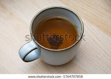Herbal tea with tea leaves at the bottom of the mug