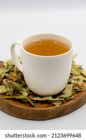 Herbal tea on a white background. Linden tea. immune-boosting herbal tea. Medicinal tea prepared from linden leaves, Clove particles and Chamomile.