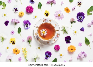 Herbal Tea In A Vintage Porcelain Mug With Spring And Summer Flowers On White Background. Flat Lay, Bright Colorful Pattern, Top View. Summer Country Creative Concept