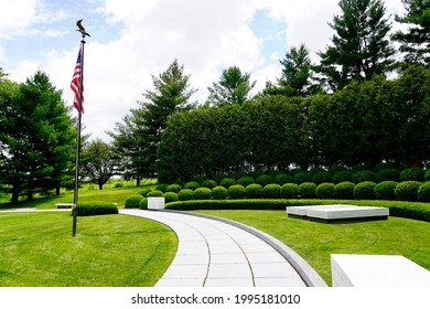 Herbert Hoover National Historic Site in West Branch, Iowa. The gravesite of President Hoover and Lou Henry Hoover. Two marble ledger stones mark graves in a semicircular landscaped plot with a flag.