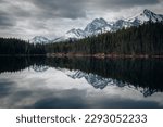 Herbert lake in Alberta, Canada on a cloudy day with stunning mountains and water reflections