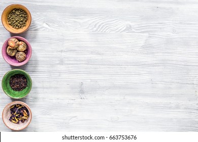 Herbs In Colorful Bowls To Make Tea On Light Table Background Top View Mock-up