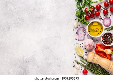 Herbs and condiments on light stone background. Top view with copy space.