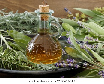 Herbs infused vinegar in bottle. Thieves vinegar, alternative medicine remedy with wormwood, sage, rosemary and lavender. Herbalism concept. - Shutterstock ID 2180616017
