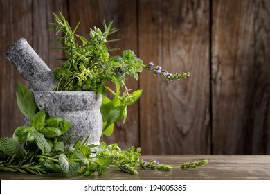 Herbs In Mortar On Wooden Background