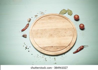 Herbs and spices on light blue wooden background. Toned.