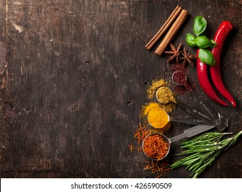 Herbs and spices on wooden table. Top view with copy space