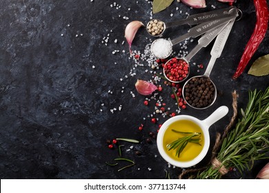 Herbs and spices over black stone background. Top view with copy space