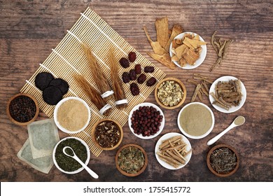 Herbs Used In Natural & Chinese Herbal Medicine To Promote Vitality, Energy & Fitness. High In Vitamins, Minerals, Antioxidants And Anthocyanins. Flat Lay On Bamboo And Rustic Wood Background.