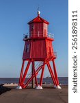 Herd Groyne Lighthouse, South Shields, UK following 2024 renovation. Built in 1882, this still operational lighthouse is known for its strange 