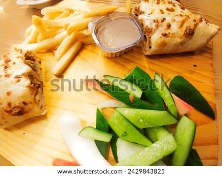 Here is a Barbie Q platter with fries and salad at brown background for food lovers and restaurant owners for their commercial uses 