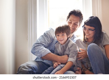 Here Comes The Tickle Monster. A Mother And Father Sitting With Their Son.