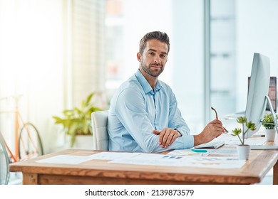 Here To Conquer The Workday. Portrait Of A Young Businessman Working In An Office.