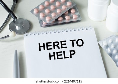here to help. text on open notepad on doctor's desk, medical concept - Shutterstock ID 2214497115