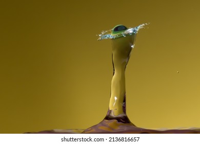 Here is a picture of water drop collision on yellow background.