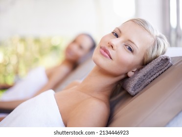 Its Here That I Let My Worries Wash Away. A Gorgeous Blond Woman Looking At You While Lying On A Spa Bed.