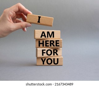 I Am Here For You Symbol. Concept Words I Am Here For You On Wooden Blocks. Beautiful Grey Background. Businessman Hand. Business And I Am Here For You Concept. Copy Space.. Conceptual Image