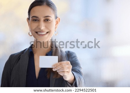 Heres my number, do pass it on as well. Portrait of a young businesswoman holding a blank card in an office. Stock photo © 