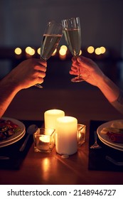 Heres to us and our future. Cropped shot of an unrecognizable couple having a celebratory toast over a candle lit dinner at night. - Shutterstock ID 2148946727