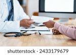 Heres your sick note for work. Closeup shot of an unrecognisable doctor giving paperwork to a patient during a consultation.
