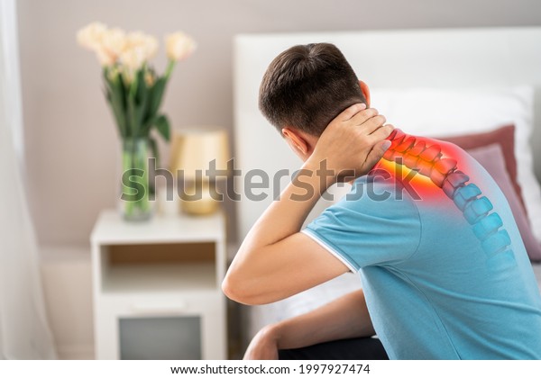 Hernia of the cervical spine, neck pain,\
man suffering from ache in the bedroom, compression injury of the\
intervertebral disc, health problems\
concept