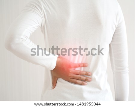 herniated disc,spondylosis and scoliosis in asian woman and she touching her back cause of strains or disc injury and spinal stenosis use for health care concept.